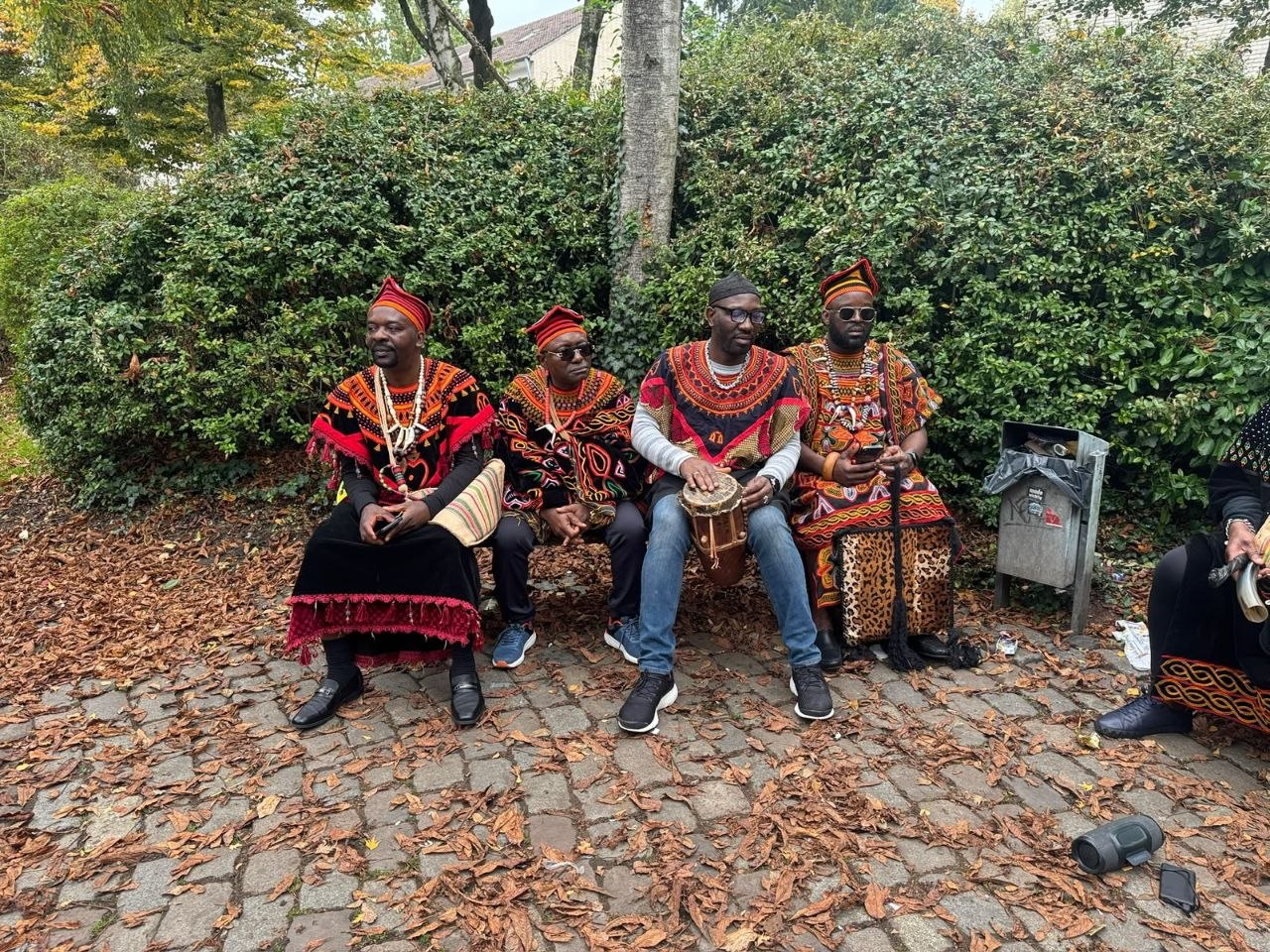 Seated members in red-and-black regalia — North West Elites e.V.